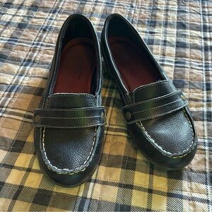 Black women’s Skechers leather slip-on shoes